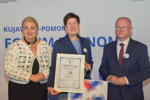 ludzie stoją w rzędzie trzymając nagrody