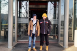 dwóch mężczyzn stoi przed wejściem do kina