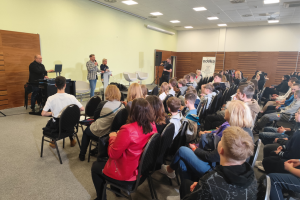 ludzie siedzą na krzesłach