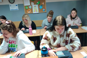 uczennice siedzą w ławkach