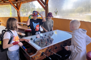 dzieci stoją przy stole do gry w piłkarzyki